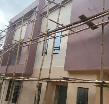 Exterior painting beside scaffolding — Gbagada, Lagos