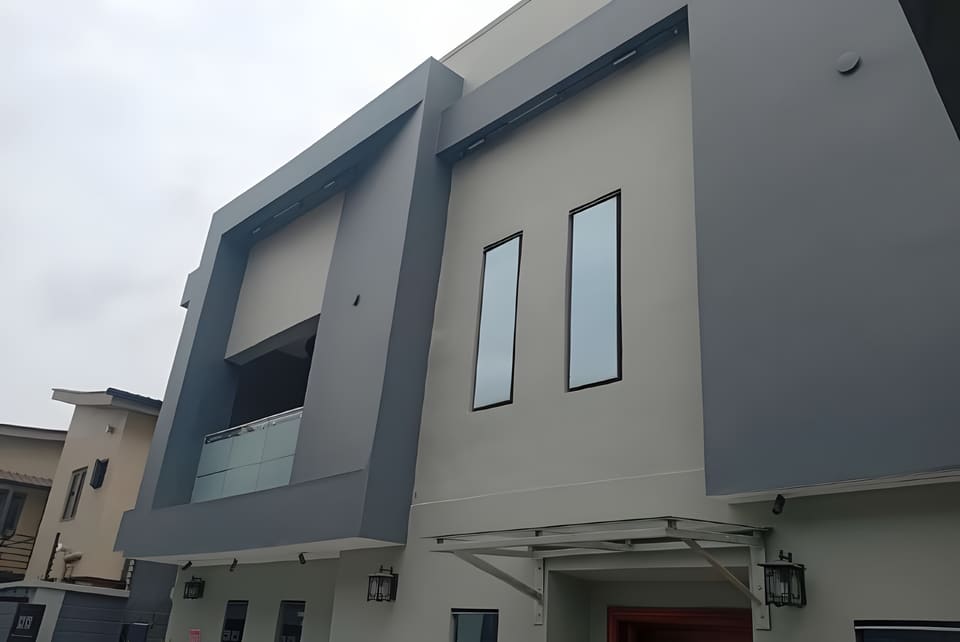 Remodelled upper facade with geometric frames and glass balcony — Gbagada, Lagos