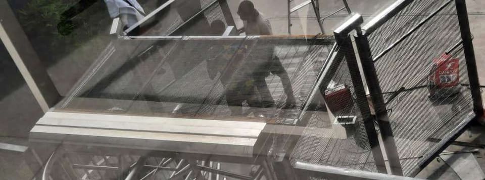 Overhead view of the metal mesh access-control enclosure — Awolowo Road, Ikoyi, Lagos