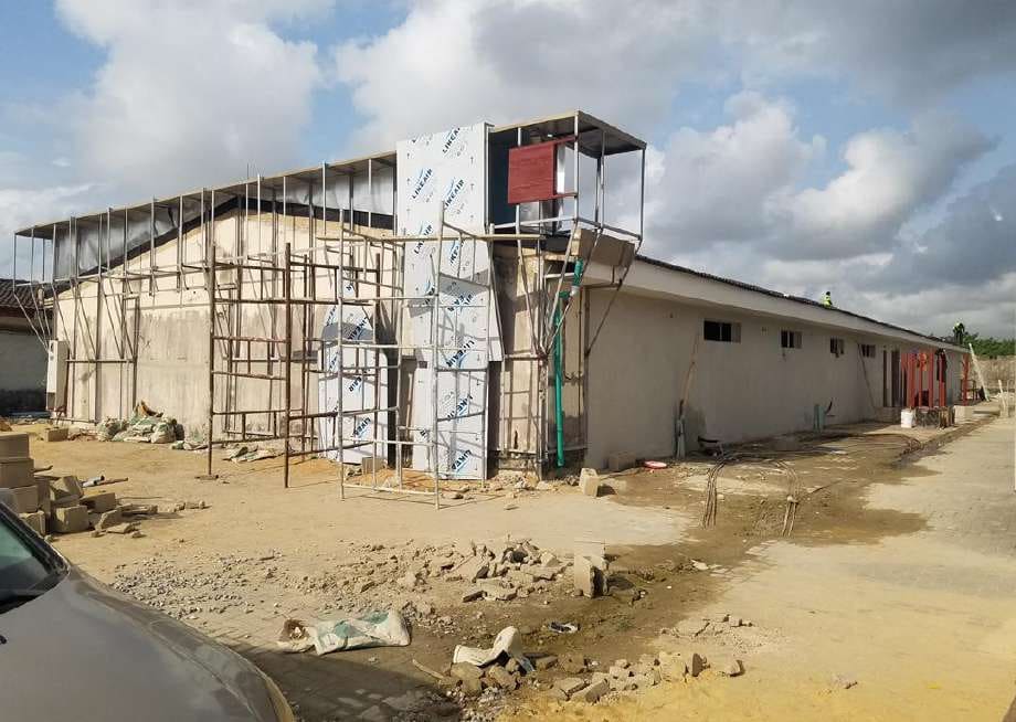 Scaffolding around the facade during cladding works — HFP Shopping Complex, Lagos