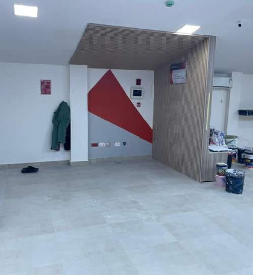 Wood-slat booth and geometric wall panels inside the branch — HFP Shopping Complex, Lagos