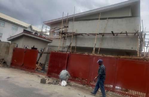 Before: scaffolded office exterior during works — Oluwaleimu Street, Ikeja, Lagos